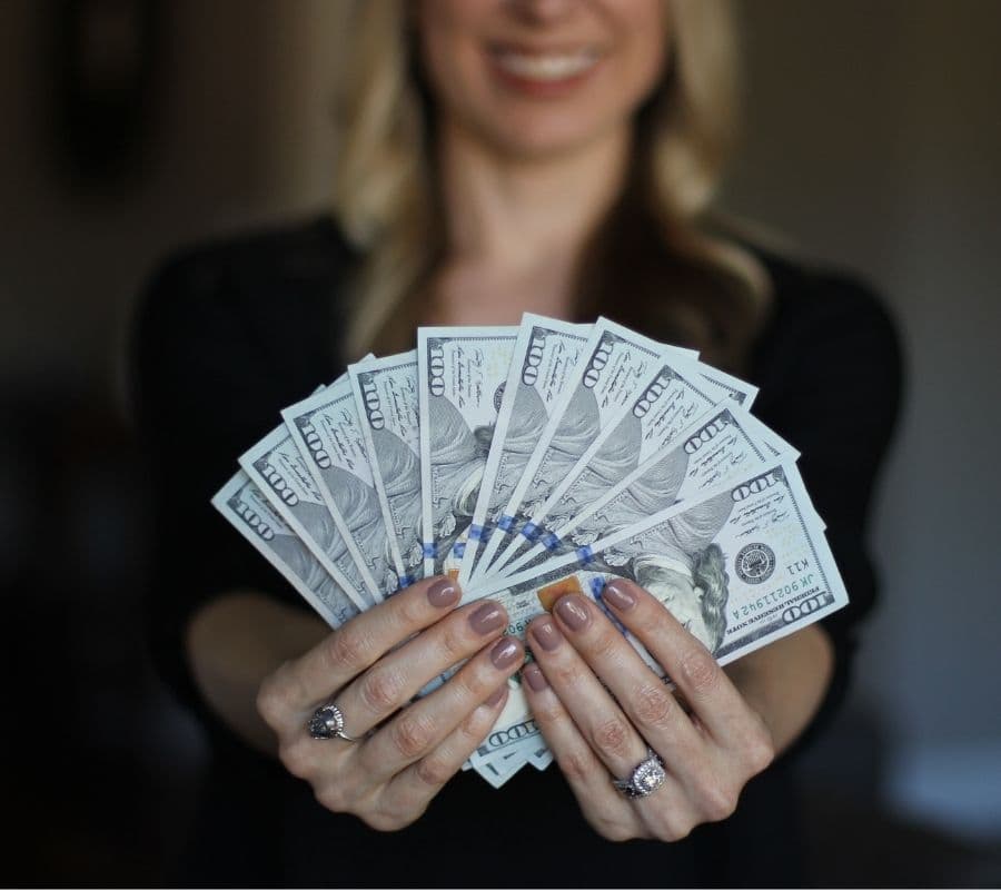 woman holding a bunch of money
