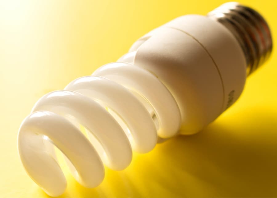 a light bulb on a yellow table