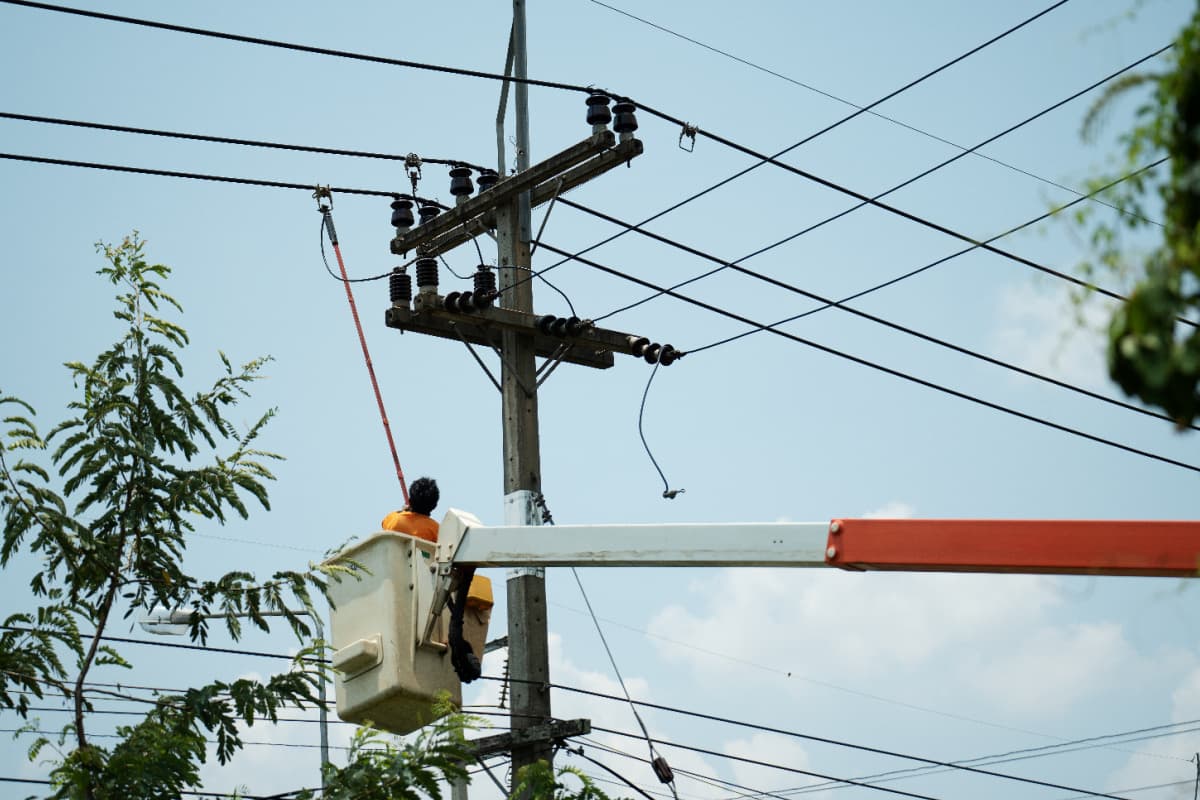 man repairing a power pole